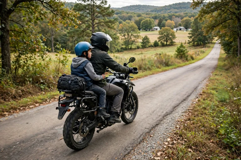Motorcycle rider with a helmeted young passenger on an Arkansas road