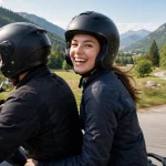 Smiling motorcycle passenger wearing a well-fitting helmet on the back of a bike