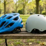 Child's bike helmet and skate helmet side by side on a bench